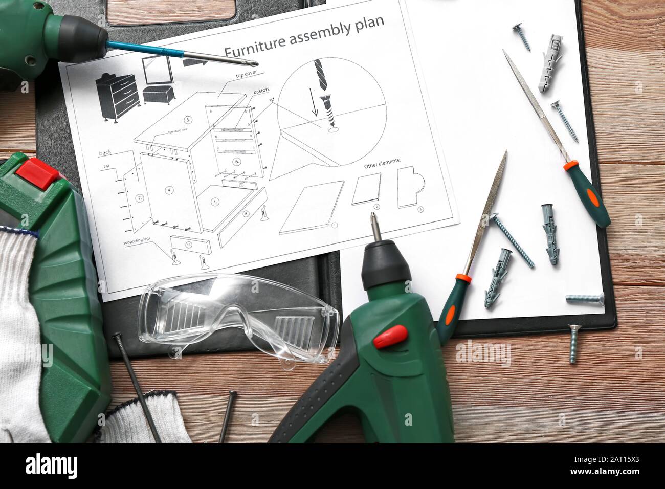 Furniture assembling plan with set of tools on table Stock Photo