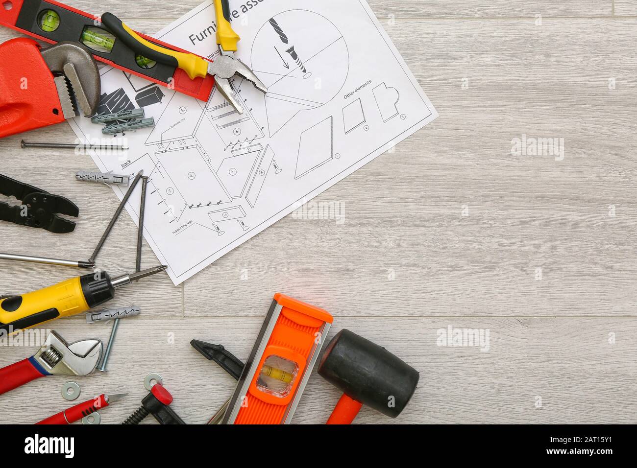 Furniture assembling plan with set of tools on table Stock Photo