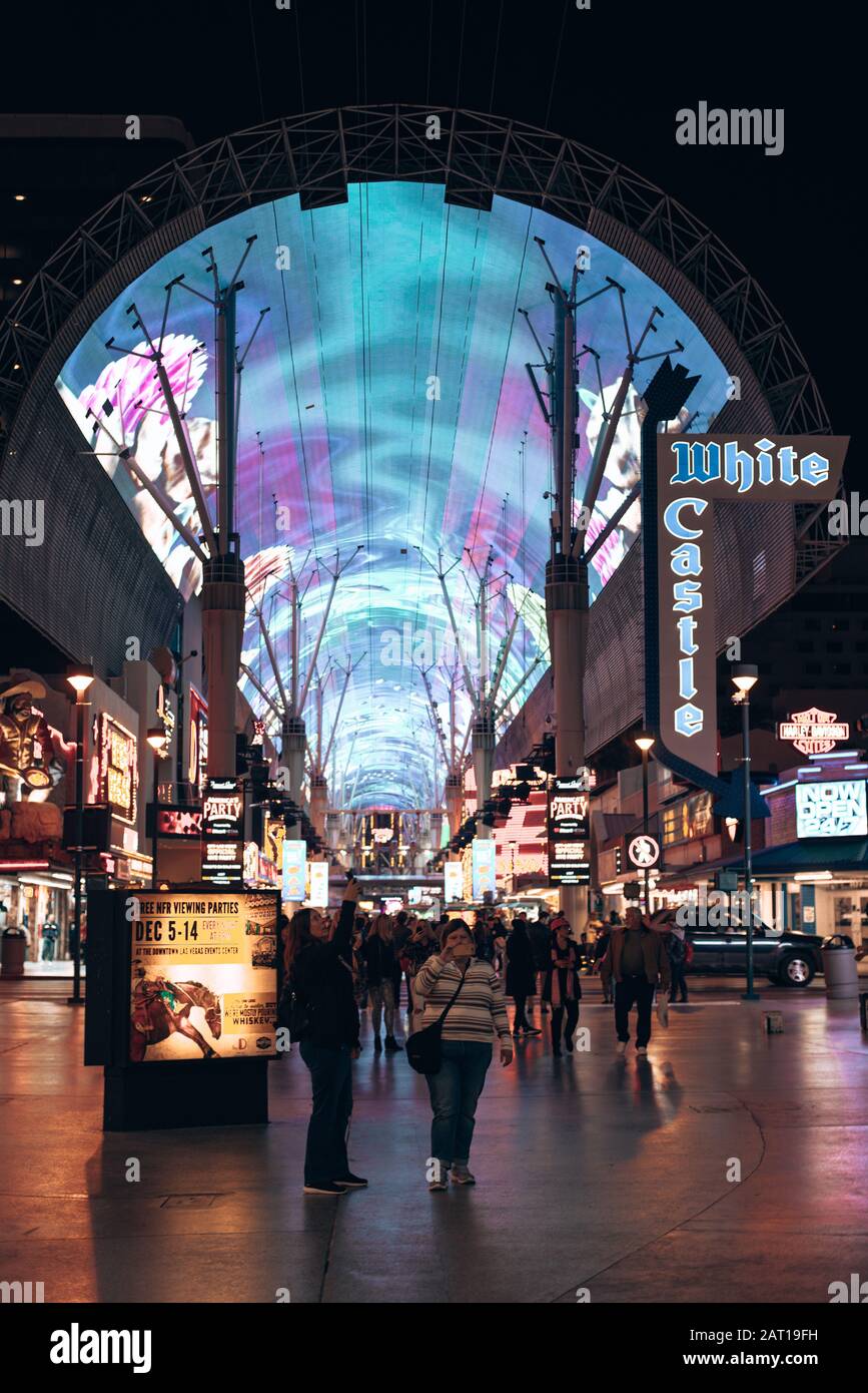 Las Vegas, USA - december, 2019 Tourists outside the Pioneer watch the Freemont Street Experience light show Stock Photo