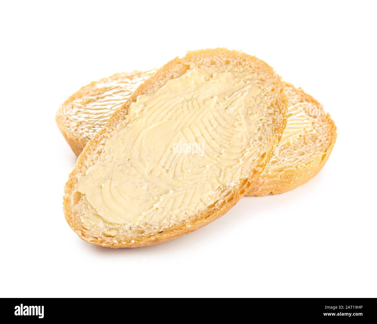 Slices of bread with butter on white background Stock Photo - Alamy
