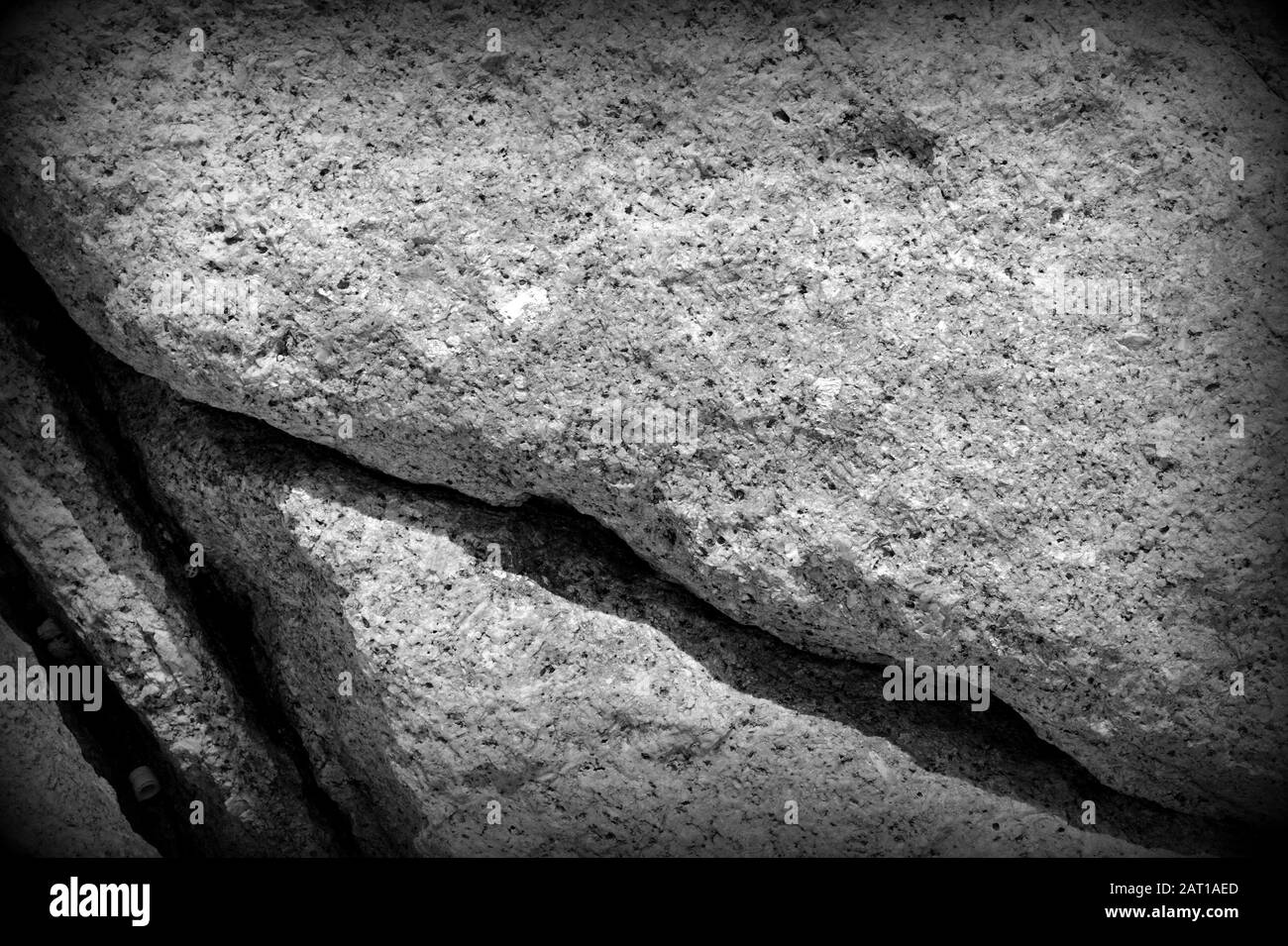 Coastal rock texture close-up. Stone background black and white Stock Photo