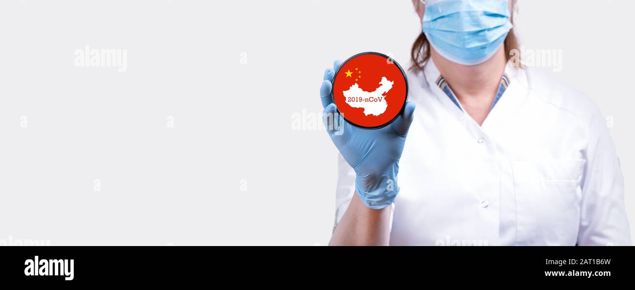 Female doctor hand holding stop sign coronavirus 2019-nCoV against flag and map of China concept banner. Stock Photo
