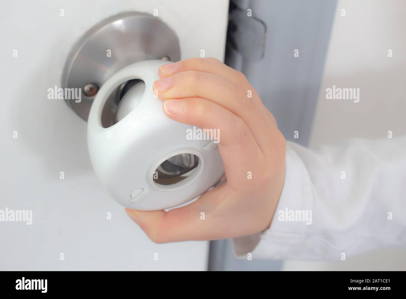 Child Proof Door Knob Covers Over Doorknob With A Kid S Hand