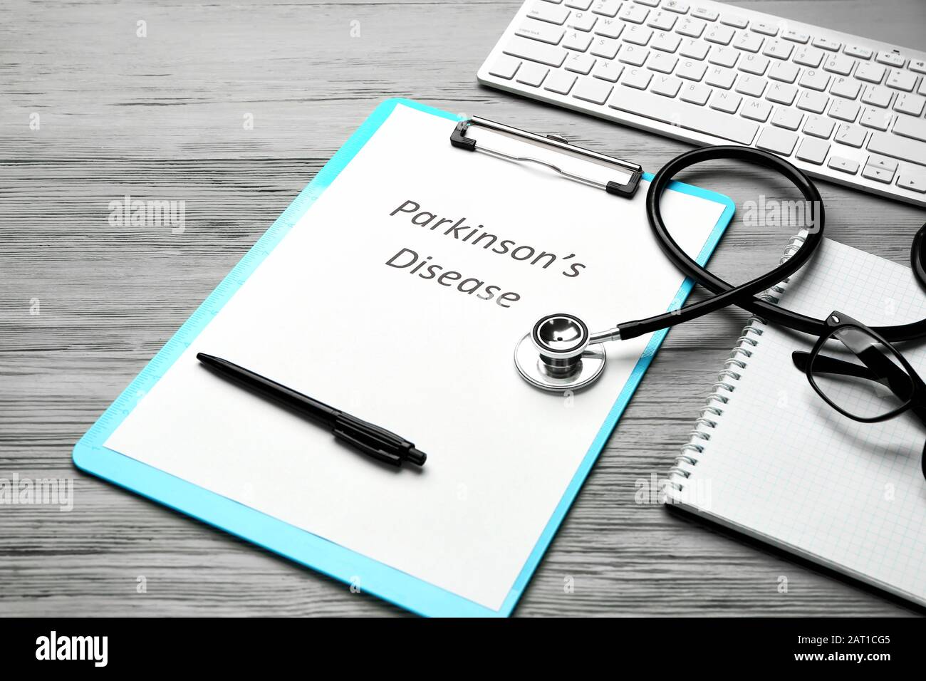 Clipboard with text PARKINSON'S DISEASE, stethoscope and computer