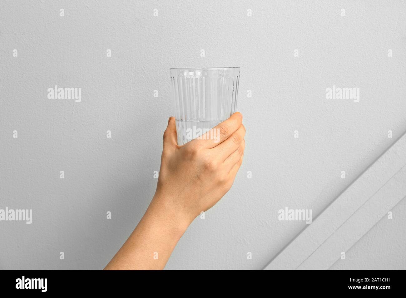 Woman Suffering From Parkinson Syndrome With Glass Of Water