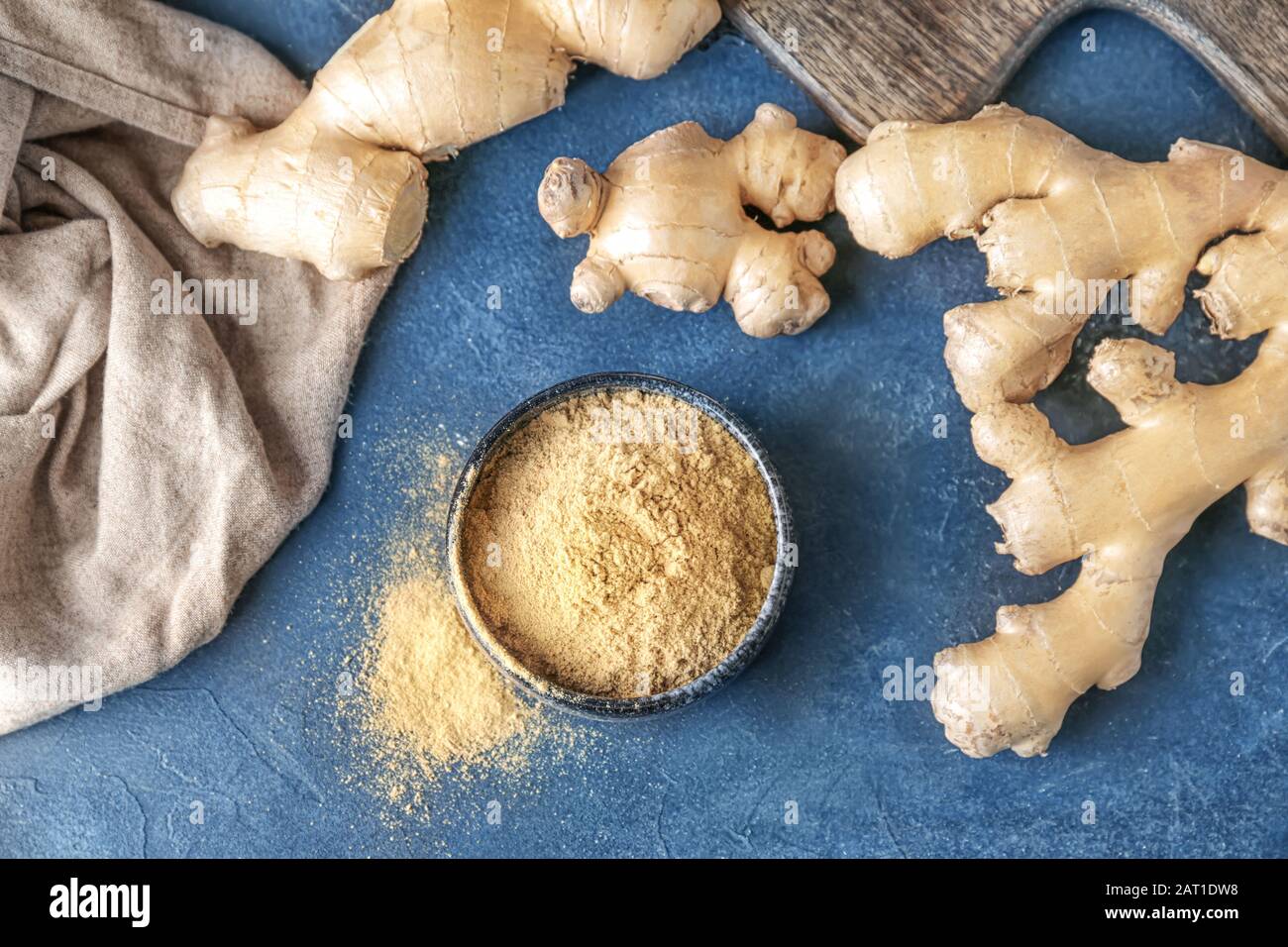 Fresh and ground ginger on dark background Stock Photo