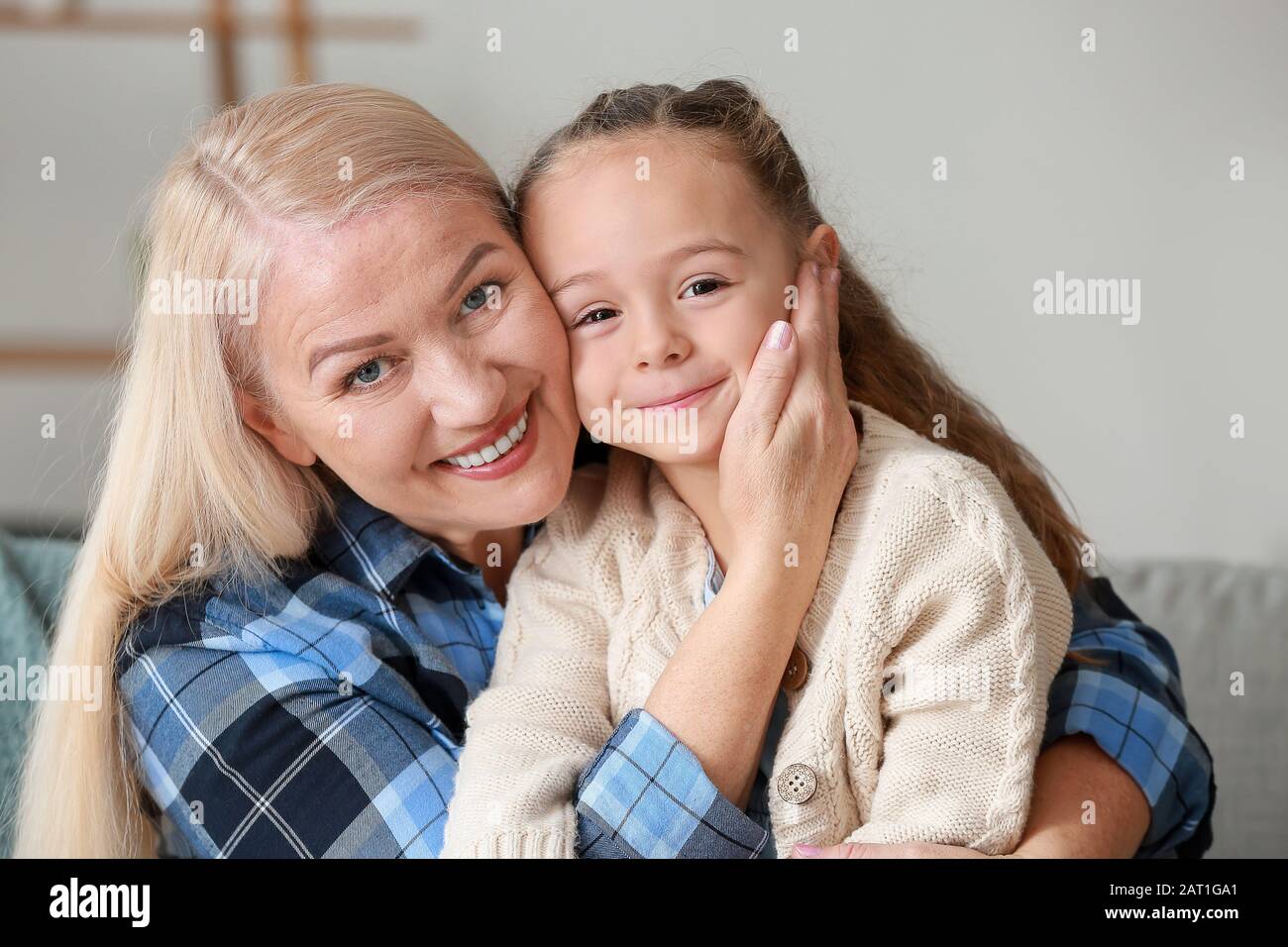 Little girl and grandmother spending time together at home Stock Photo