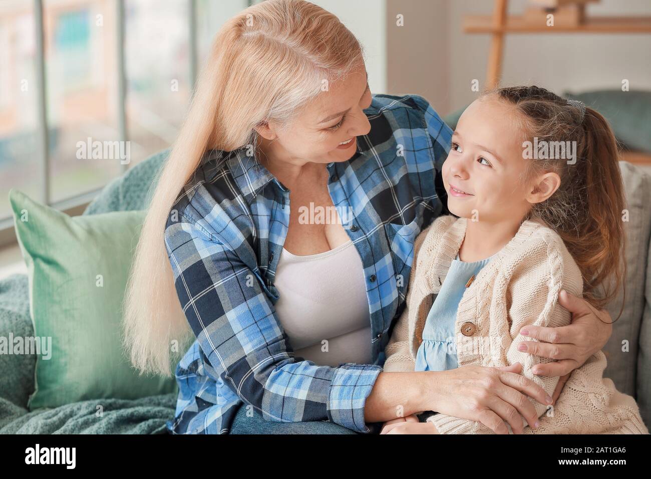 Little girl and grandmother spending time together at home Stock Photo