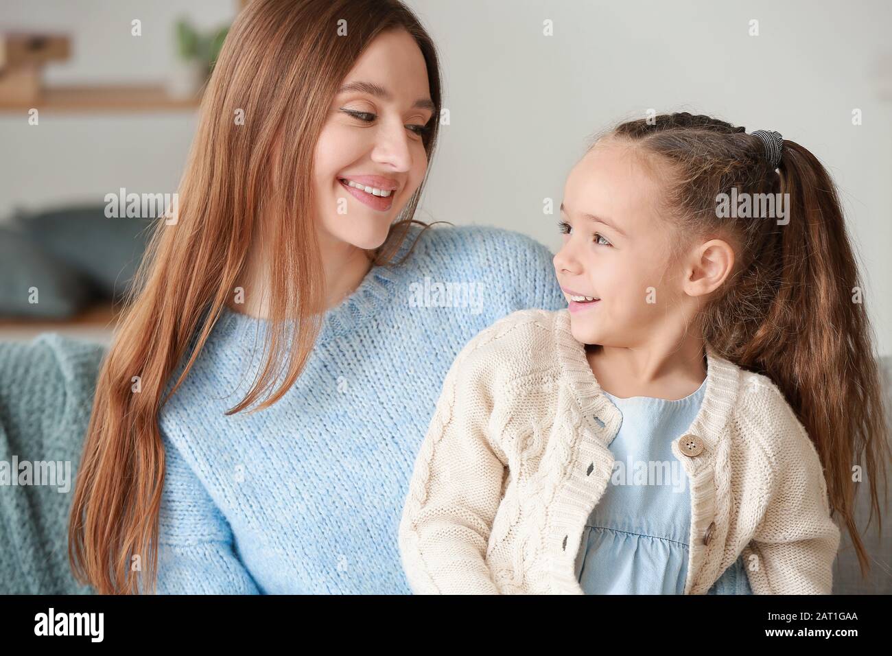 Little girl and mother spending time together at home Stock Photo