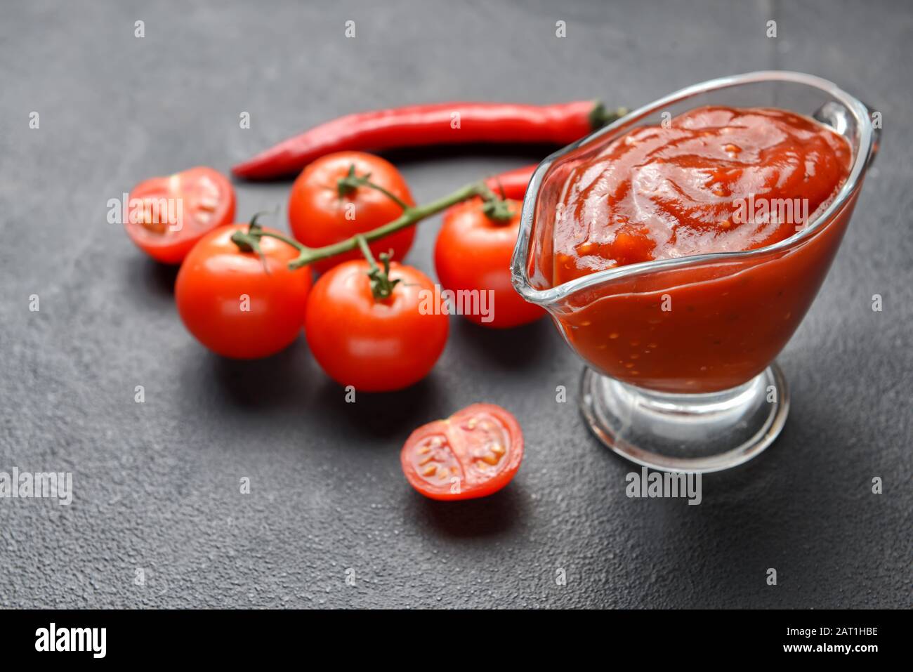 Gravy-boat with tasty barbecue sauce on table Stock Photo