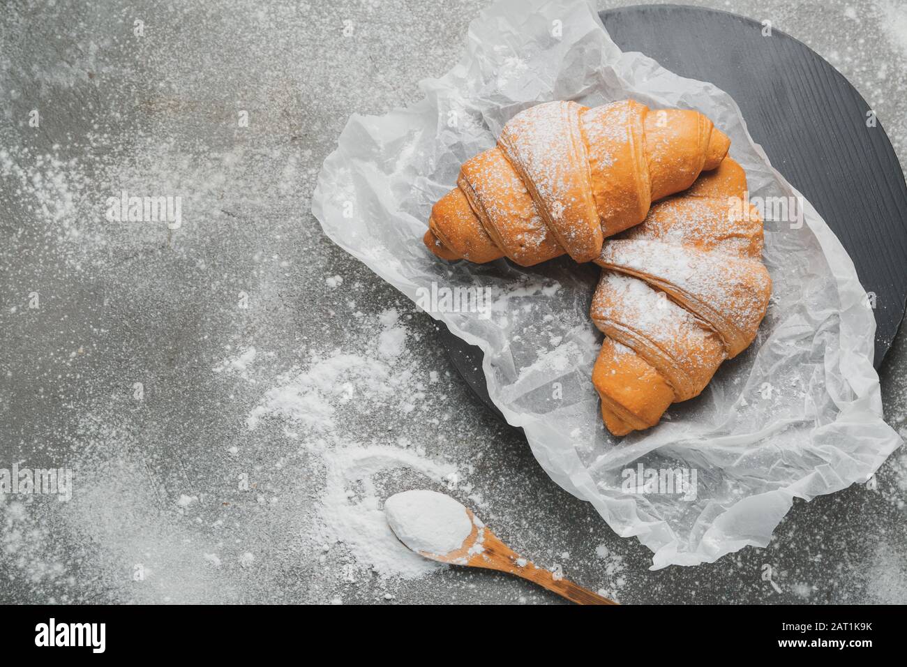 Tasty croissants on grey table Stock Photo