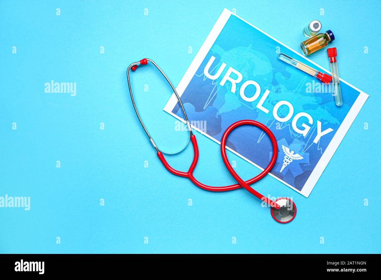 Paper sheet with text UROLOGY, stethoscope and medicines on color