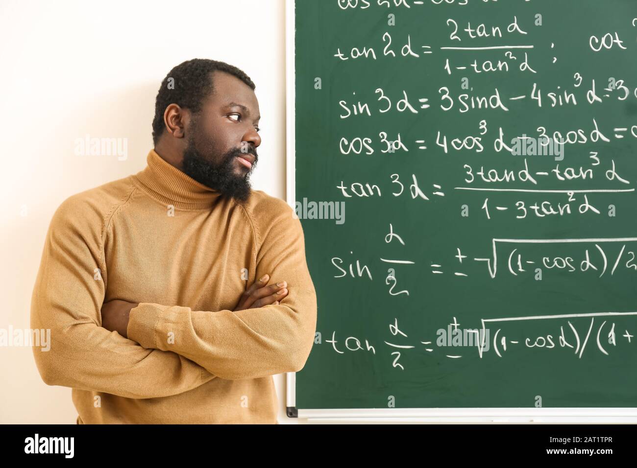african-american-math-teacher-near-blackboard-in-classroom-stock-photo-alamy