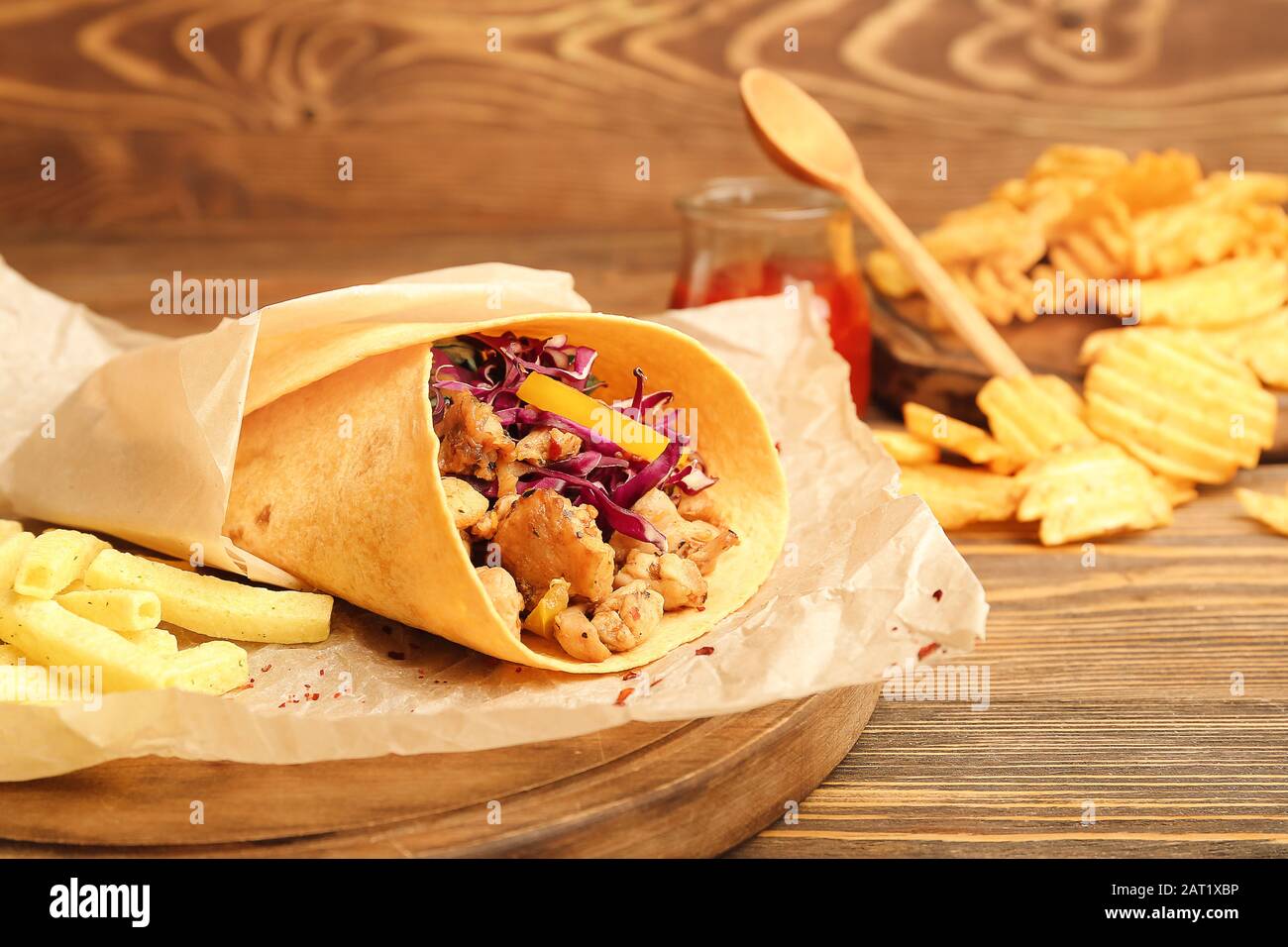 Tasty doner kebab, chips and french fries on wooden background Stock Photo