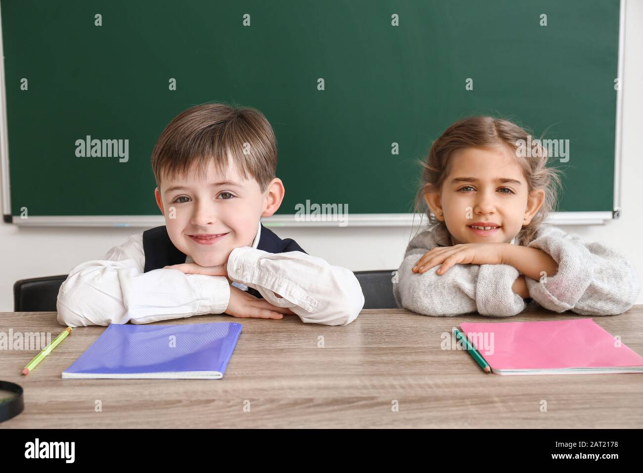 Little pupils sitting at desk in classroom Stock Photo - Alamy