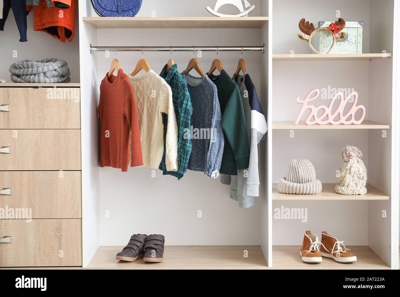 Modern Wardrobe With Stylish Winter Clothes And Accessories Stock