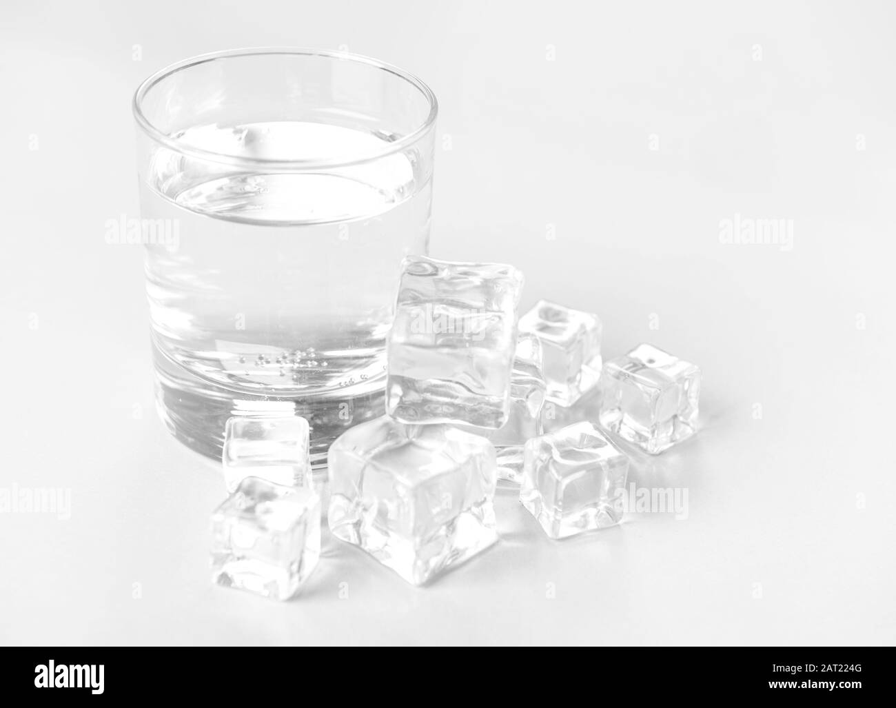 Glass of clean water and ice cubes on light background Stock Photo Alamy