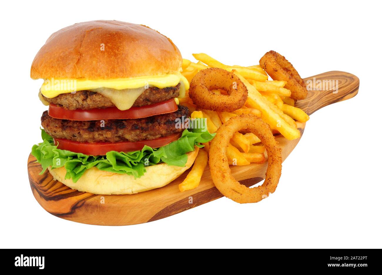 Cheese beef burger and French fries with battered onion rings on an olive wood serving board isolated on a white background Stock Photo