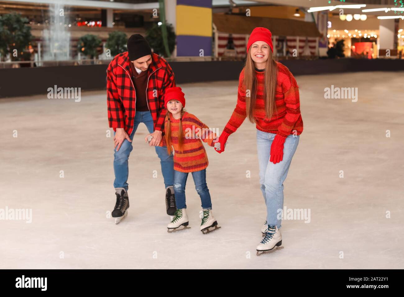 Happy family on skating rink Stock Photo