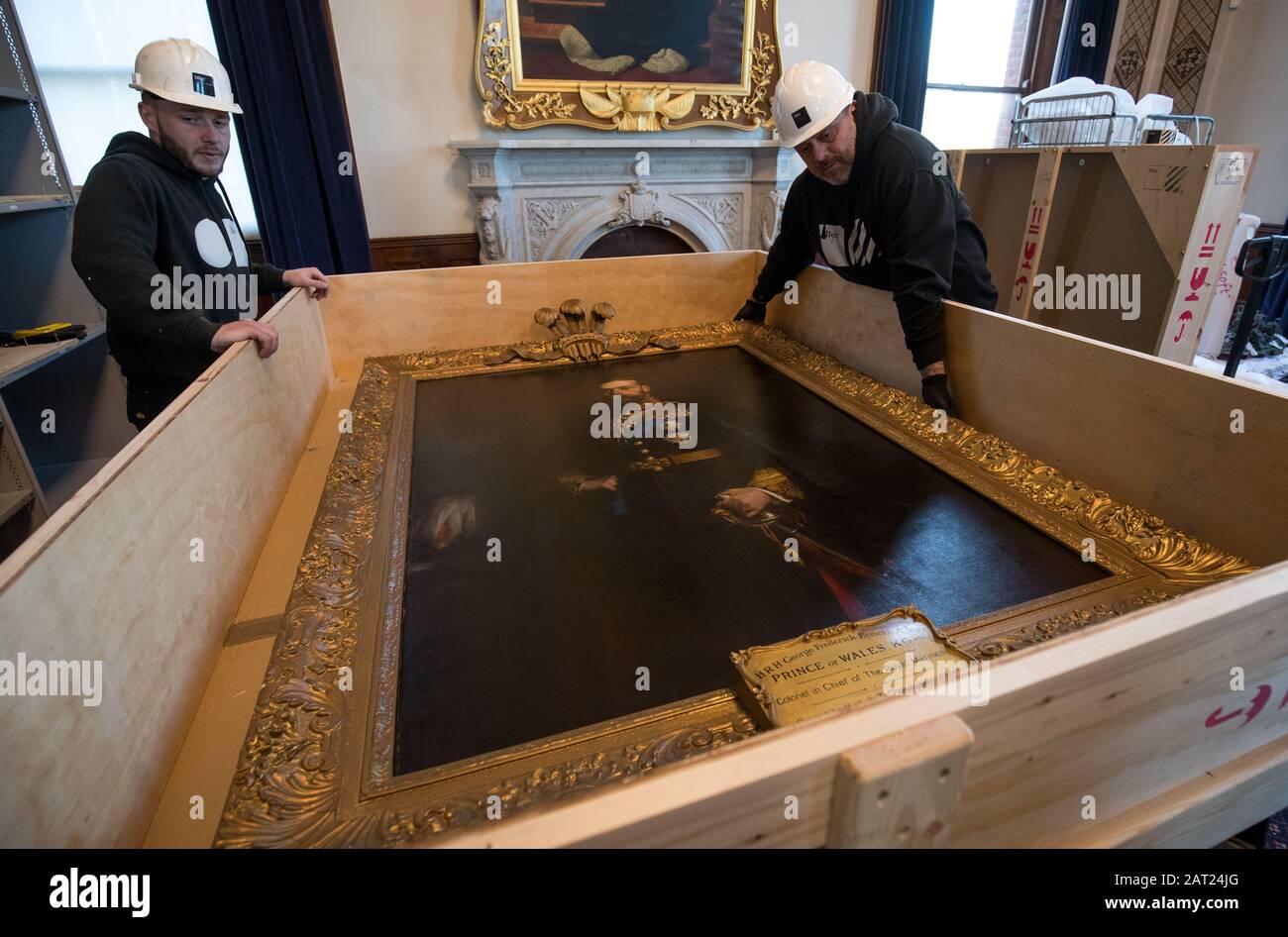 A painting of His Royal Highness George Frederick Ernest Albert Prince of Wales by artist Hugh de Twenebrokes Glazebrook is placed into a crate as workmen pack away paintings following the closure of the Royal Marines Museum, in Eastney, Portsmouth. Stock Photo