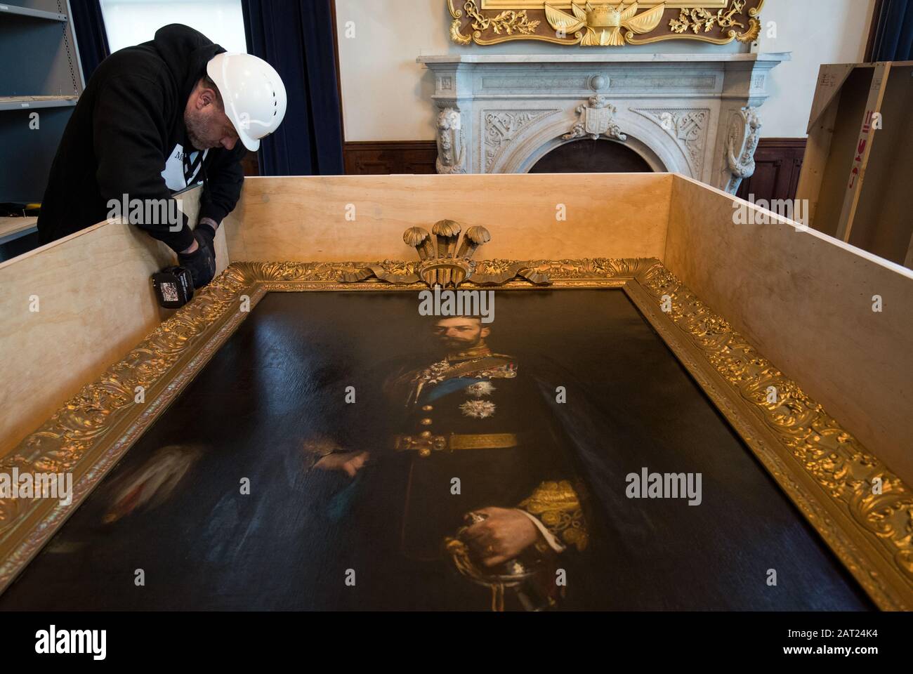 A painting of His Royal Highness George Frederick Ernest Albert Prince of Wales by artist Hugh de Twenebrokes Glazebrook is placed into a crate as workmen pack away paintings following the closure of the Royal Marines Museum, in Eastney, Portsmouth. Stock Photo