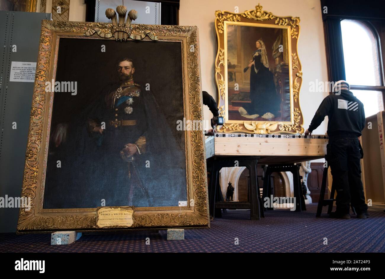 A painting of His Royal Highness George Frederick Ernest Albert Prince of Wales by artist Hugh de Twenebrokes Glazebrook waits to be packed away by workmen following the closure of the Royal Marines Museum, in Eastney, Portsmouth. Stock Photo