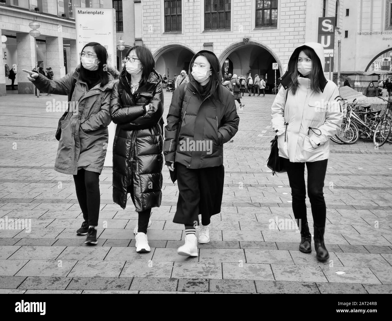Munich, Bavaria, Germany. 30th Jan, 2020. A group of people are among the increasing number of tourists and residents of the city of Munich, Germany wearing breathing masks on the streets in response to Germany's first case of Corona Virus in nearby Starnberg. The affected was infected by a Chinese coworker visiting from Shanghai and is currently at Klinikum Schwabing in Munich. Credit: Sachelle Babbar/ZUMA Wire/Alamy Live News Stock Photo