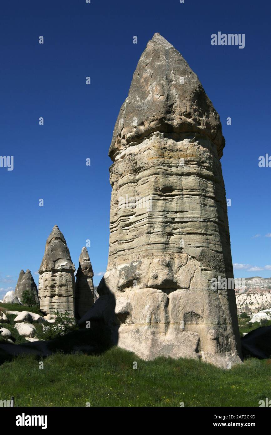 Unique volcanic rock formations known as a fairy chimneys. They are located in Love Valley near Goreme in the Cappadocia region and are a result of a Stock Photo