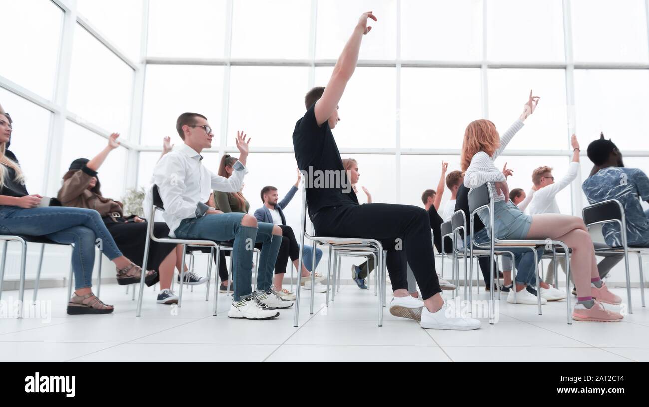group of young people sitting in a bright conference room Stock Photo ...