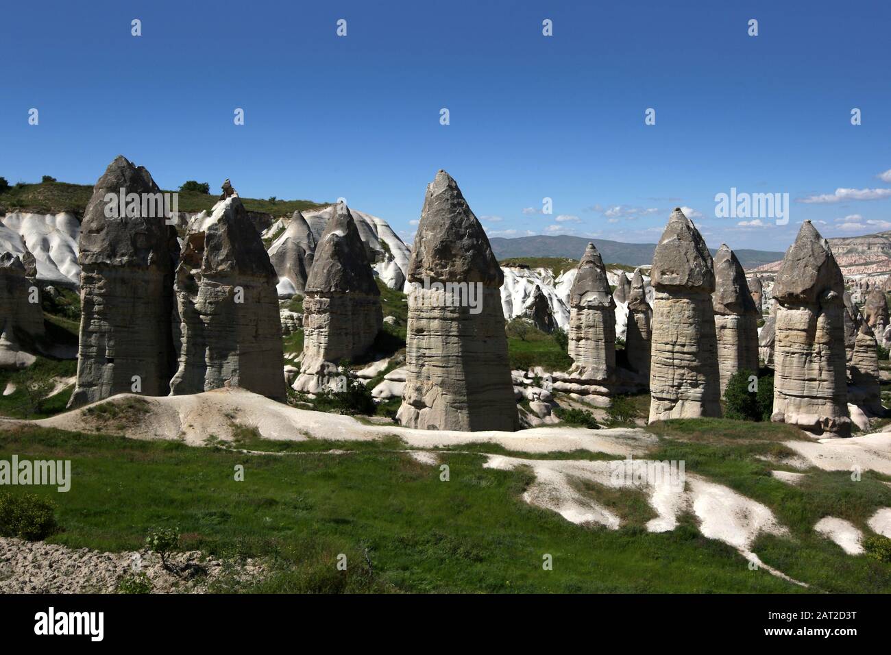 Unique volcanic rock formations known as a fairy chimneys. They are located in Love Valley near Goreme in the Cappadocia region and are a result of a Stock Photo