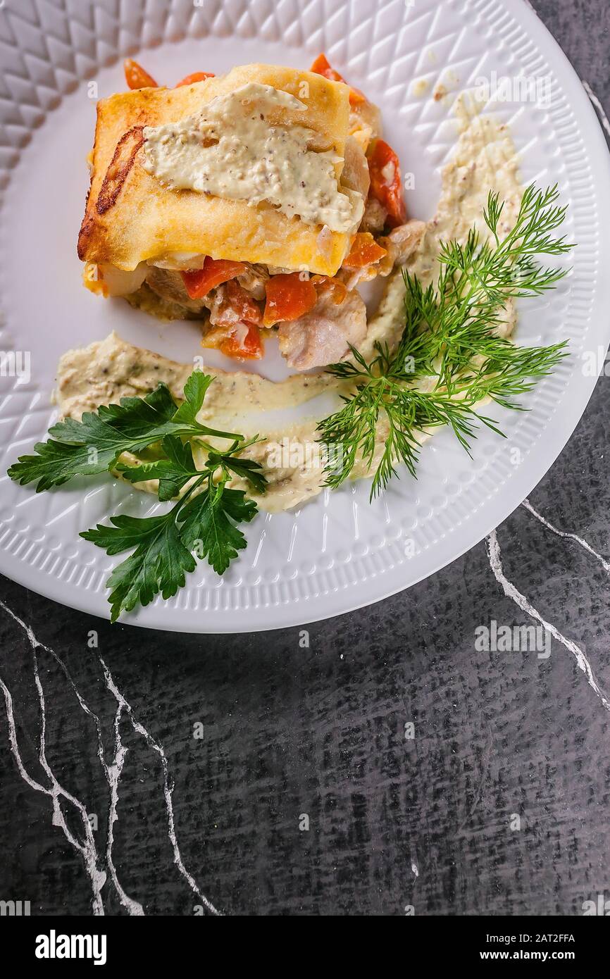 Vertical shot potato casserole with meat and vegetables, parsley, dill and sauce. Tasty and healthy food. Copy space Stock Photo