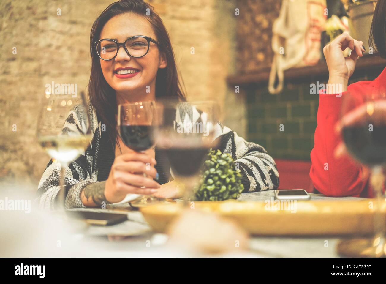 Happy friends drinking wine inside vintage trendy bar Fashion people