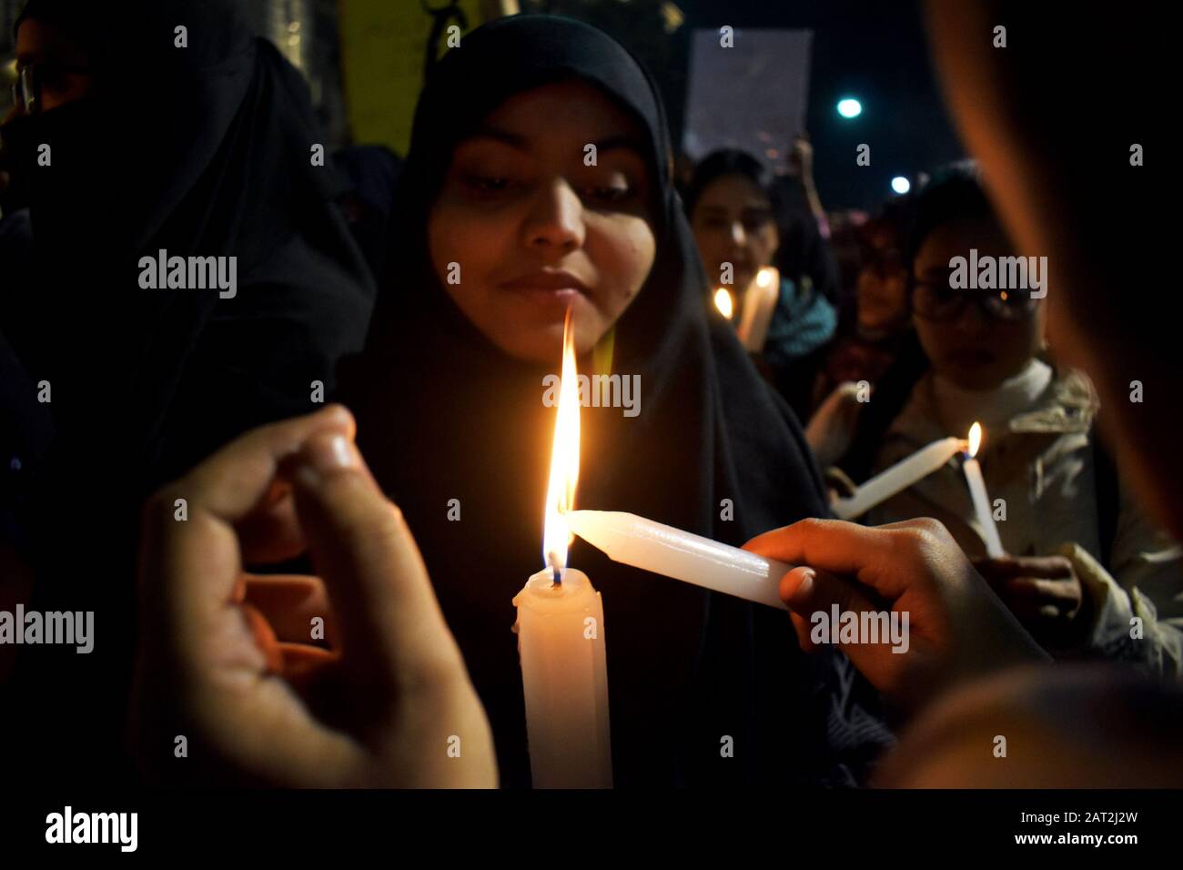 Common peoples and students are holding placards and candle during a protest rally against National Register of Citizens (NRC) in Kolkata, India. Stock Photo