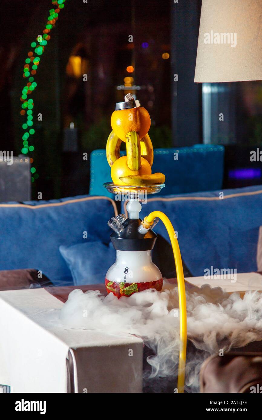 Hookah on oranges and bananas. A hookah bowl consists of two oranges