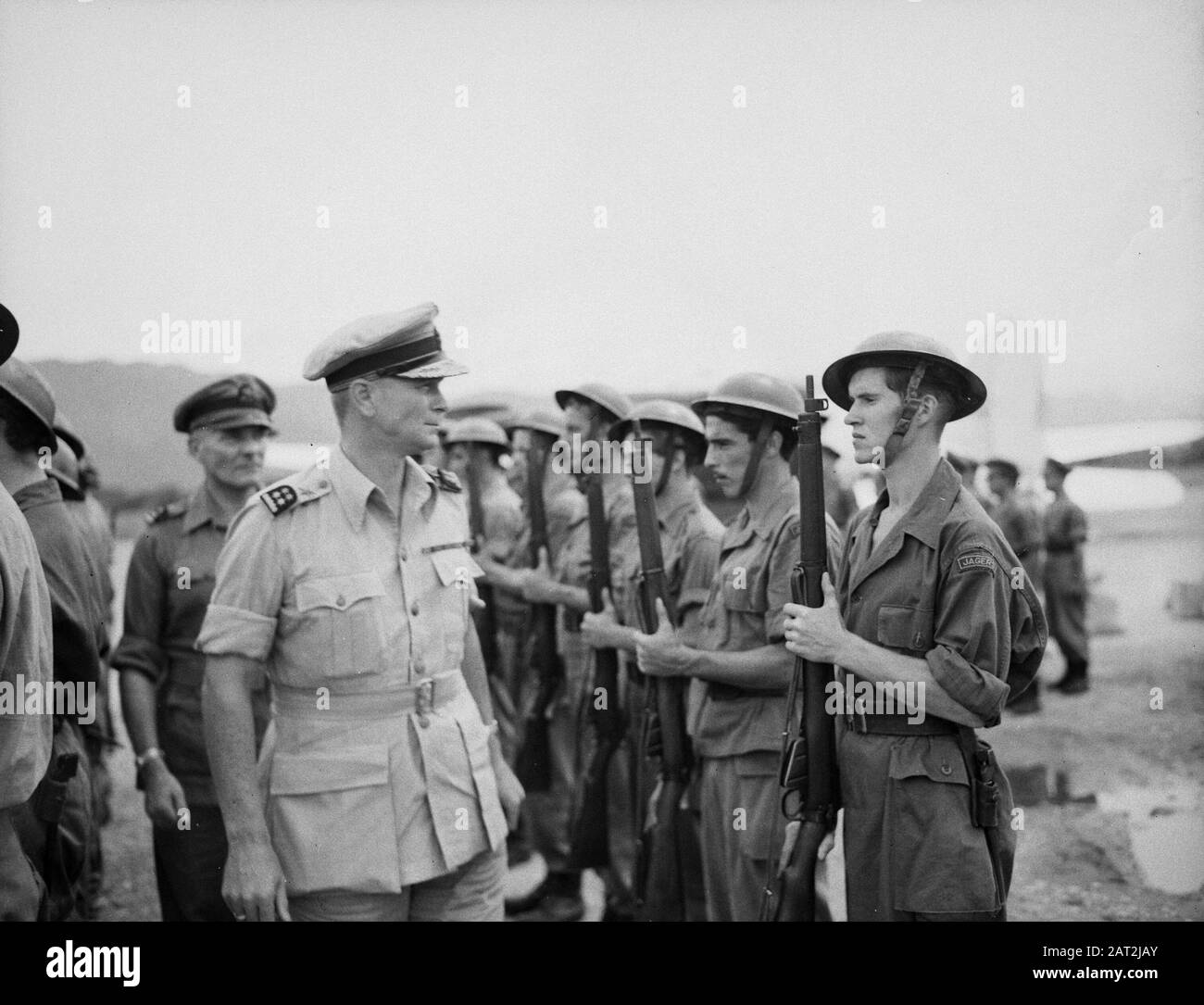 Shipping of the U-Brigade from Batavia to Padang (4th series)  General D.C. Neighbor van Vreeden has arrived at the airport. Together with Colonel J.W. Sluyter, commander U-Brigade, he inspects the Honor Guard Annotation: He was in company of a commission implementing a file Date: 2 December 1946 Location: Indonesia, Dutch East Indies, Padang, Sumatra Stock Photo