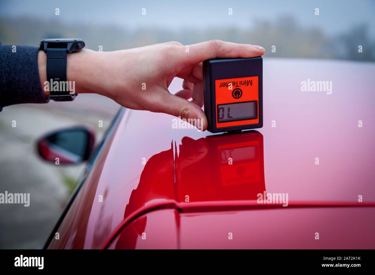 Measuring the thickness of the car paint coating red color using a