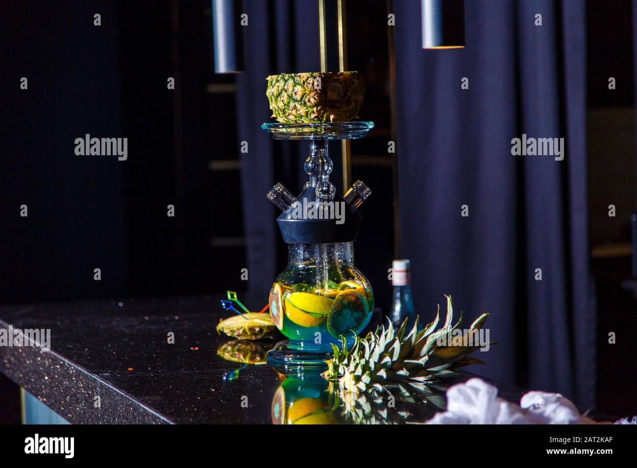 Manufacturing of hookah in the pineapple. The cut pineapple lies in the