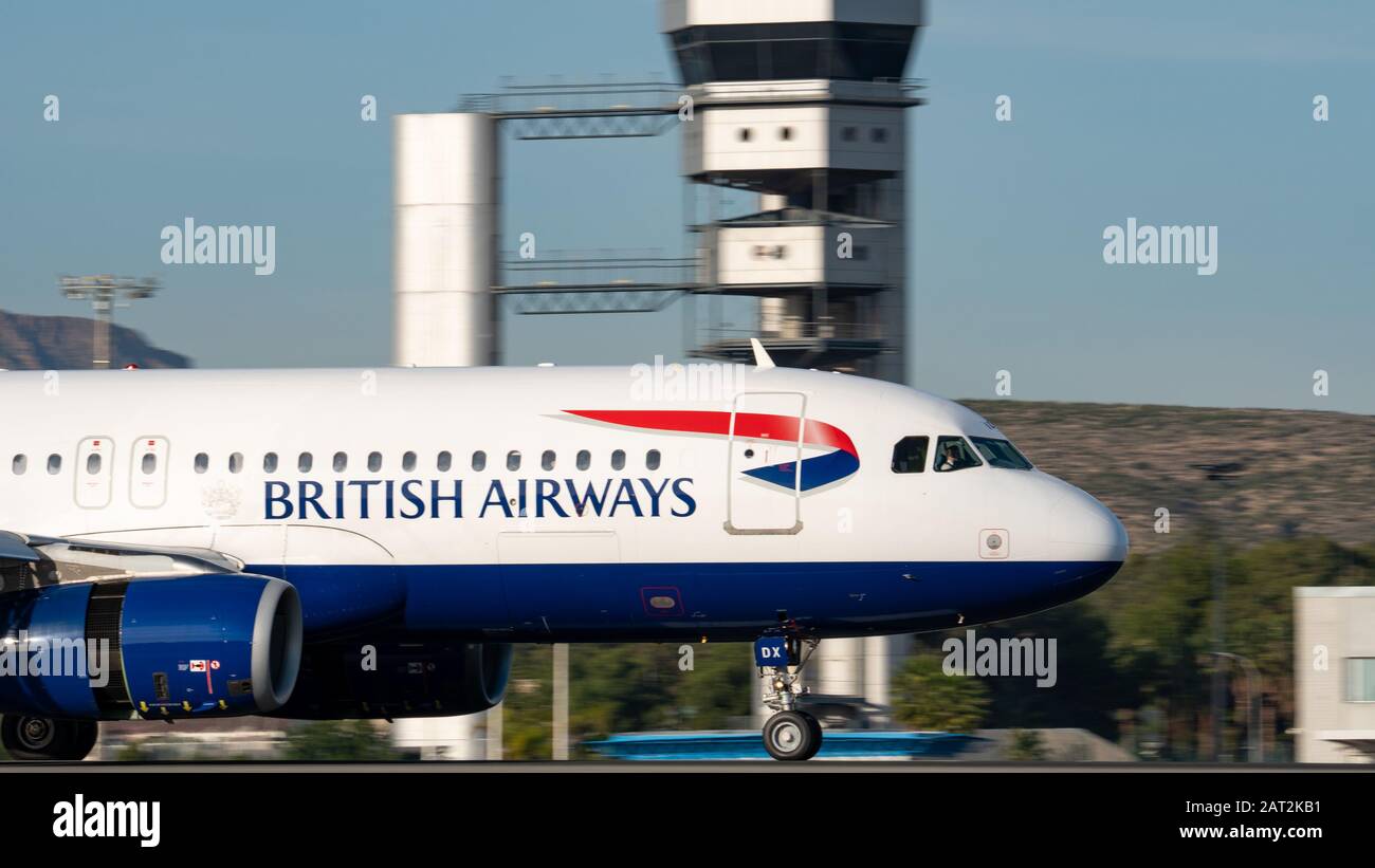 British airways plane landing with control tower Stock Photo