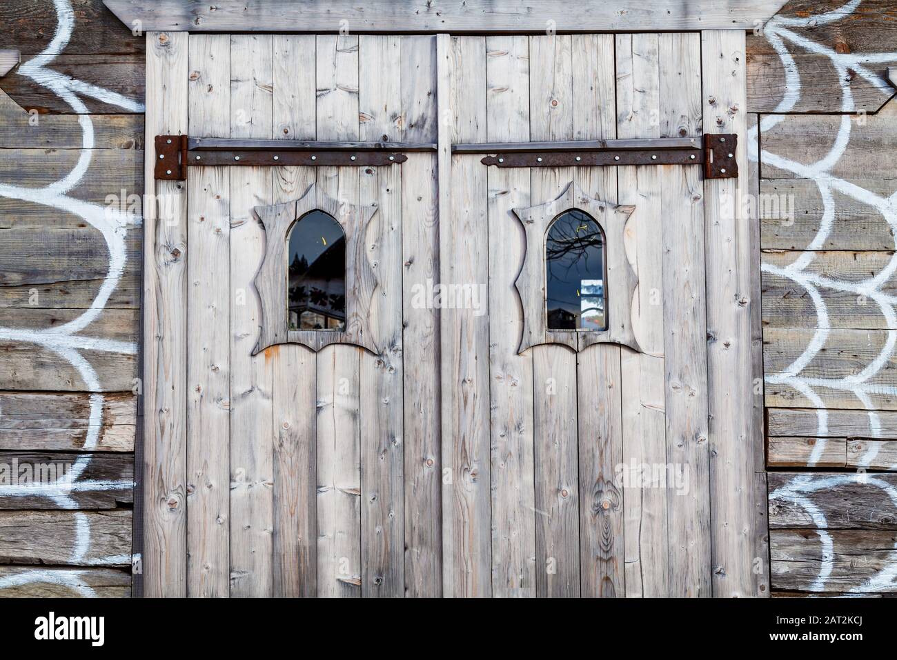 An Ancient Wooden Door With Small Glass Windows And Decorative