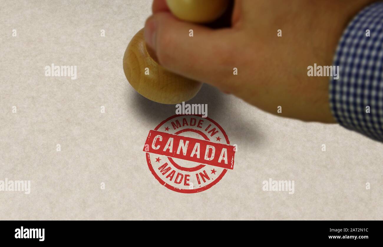 Made in Canada stamp and stamping hand. Factory, manufacturing and production country concept. Stock Photo