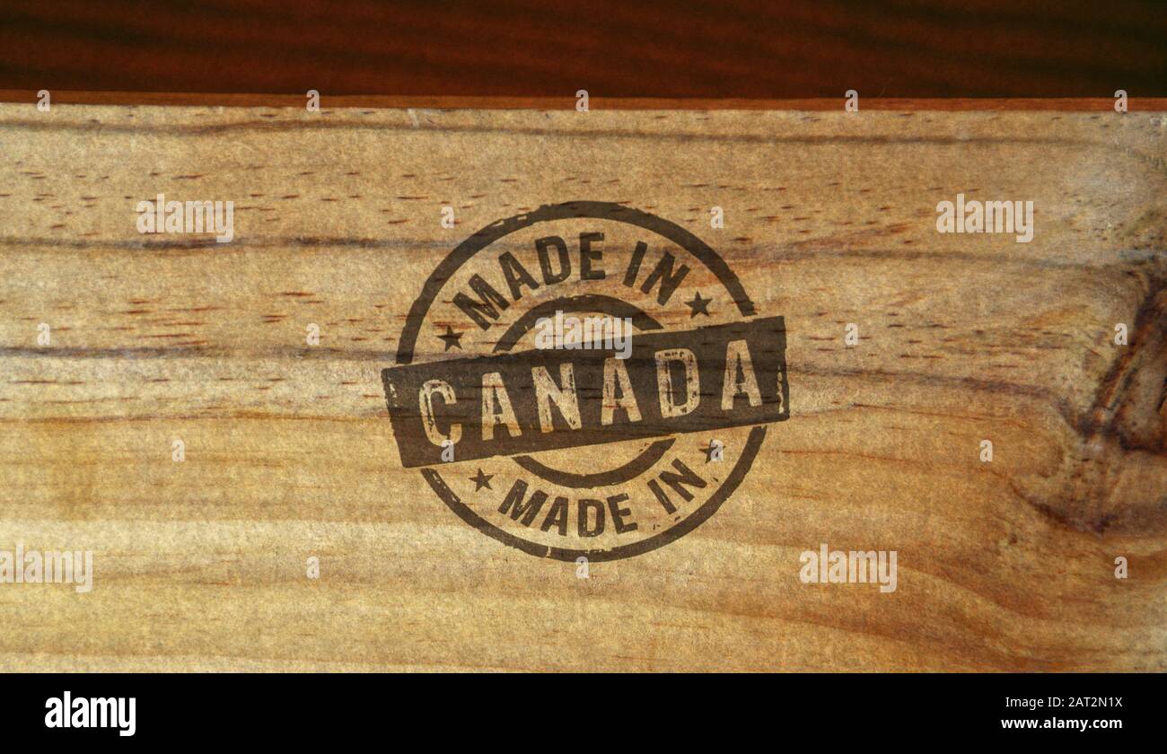 Made in Canada stamp printed on wooden box. Factory, manufacturing and production country concept. Stock Photo