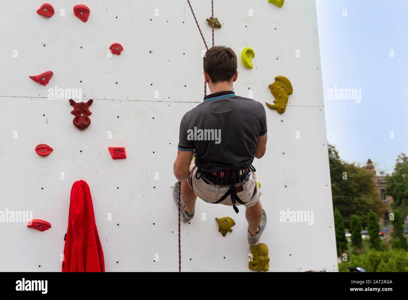 Man climbing artificial boulders during exercise. Rock climbing Stock