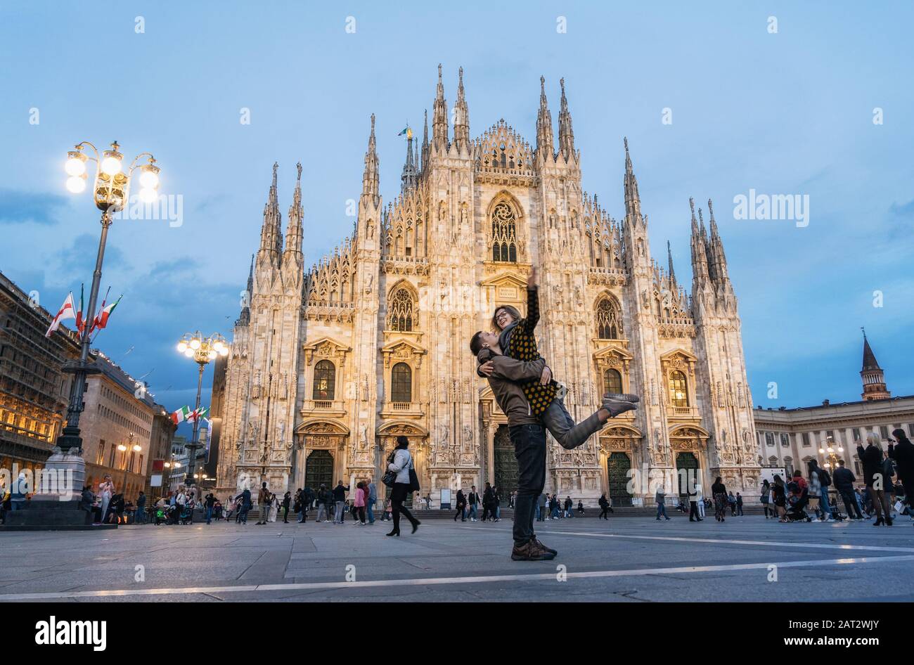 Romantic young couple embracing in front of the Duomo, Milan, Italy Stock Photo