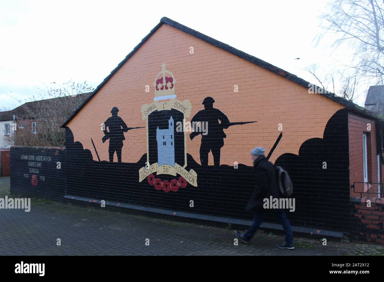 Belfast, Ireland. 29th Jan, 2020. A man walks past a mural in a Protestant quarter of Belfast. The picture recalls the battle of the 36th Ulster Division in the Battle of the Somme during the First World War. (to 'Return to Violence? Northern Ireland's Protestants smell 'treason') Credit: Christoph Driessen/dpa/Alamy Live News Stock Photo