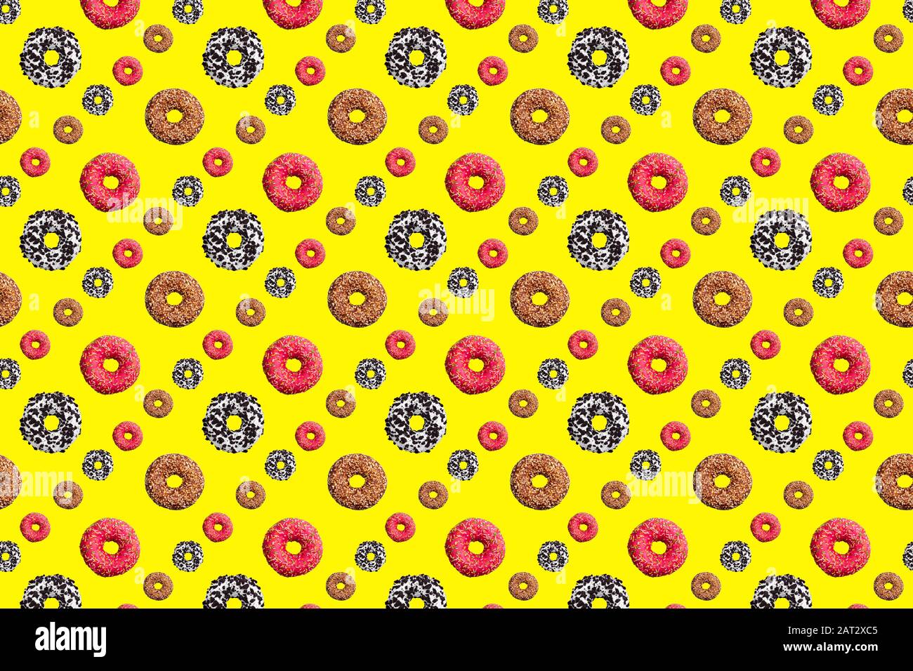 Pattern of pink and chocolate donuts on bright yellow background top ...
