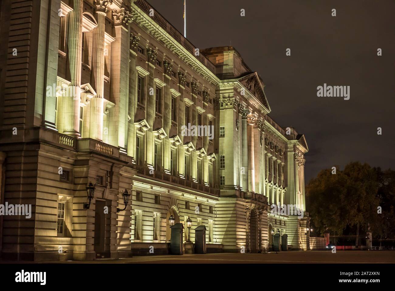 Angled detailed close side view of the famous Buckingham Palace exterior front facade lit up at night on cold November evening. Royal palace residence. Stock Photo