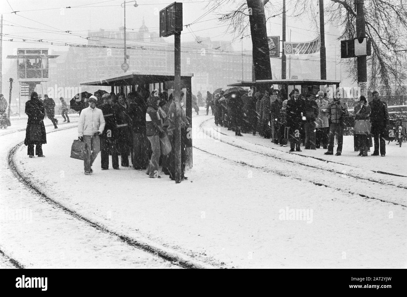 Large snowfall makes traffic impossible or hardly possible; no train traffic at CS Amsterdam, long queues waiting for tram stops at CS Amsterdam/Date: February 14, 1979 Location: Amsterdam, Noord-Holland Keywords: passengers, snow, tram stops, traffic Stock Photo