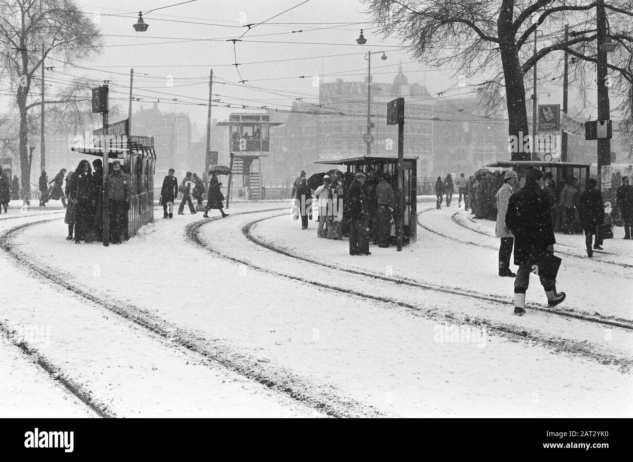 Large snowfall makes traffic impossible or hardly possible; no train traffic at CS Amsterdam, long queues waiting for tram stops at CS Amsterdam Date: 14 February 1979 Location: Amsterdam, North -Holland Keywords: passengers, snow, tramshaltes Stock Photo