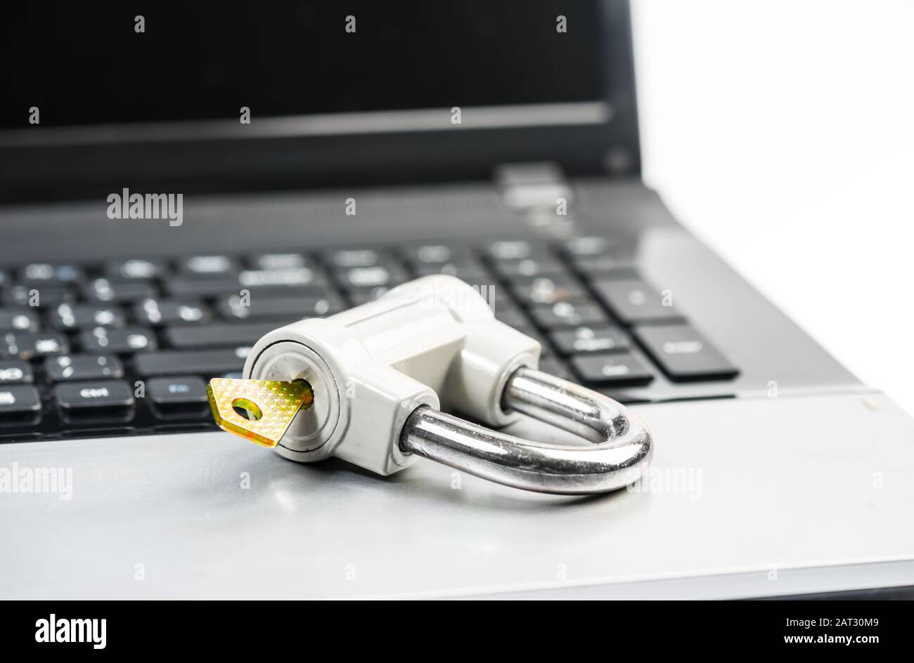 Computer security concept with a padlock on a laptop keyboard Stock Photo