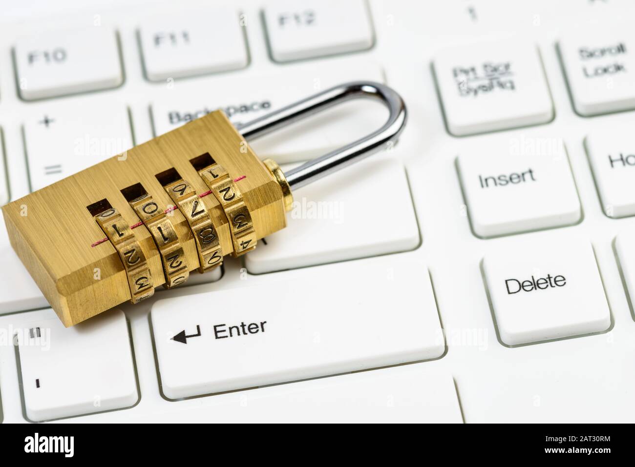 Computer security concept with combination lock padlock on white keyboard Stock Photo